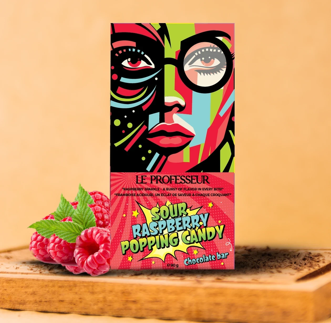 Le Professeur Sour Raspberry Popping Candy chocolate bar with vibrant pop-art packaging and fresh raspberries.