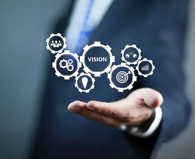 Businessman presenting digital icons representing vision, strategy, and innovation through interconnected gears.